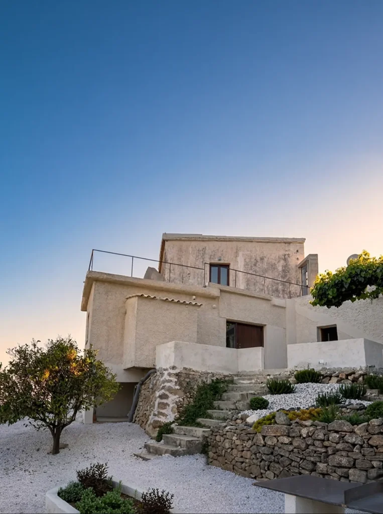 Exterior architecture of Anasa House with stone steps and Mediterranean landscaping